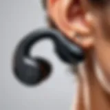 Close-up of wireless earbuds with ear hooks showcasing their ergonomic design